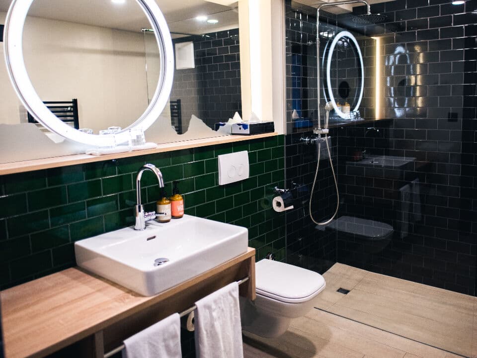 Modern bathroom with walk-in shower and basin showing accessible annexe wet room design